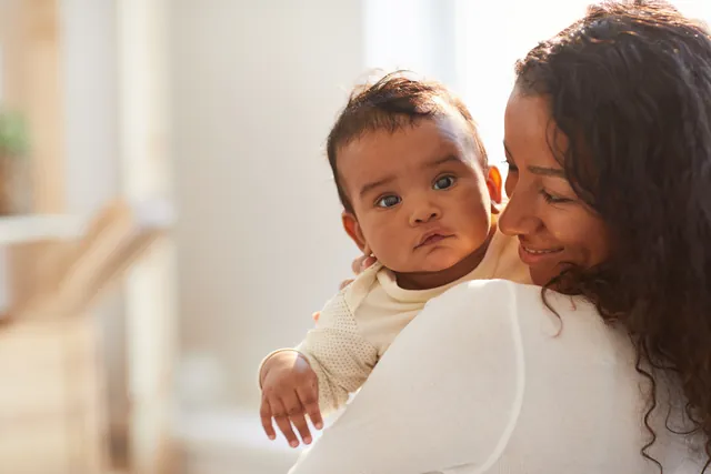 Mother holding her baby and smiling